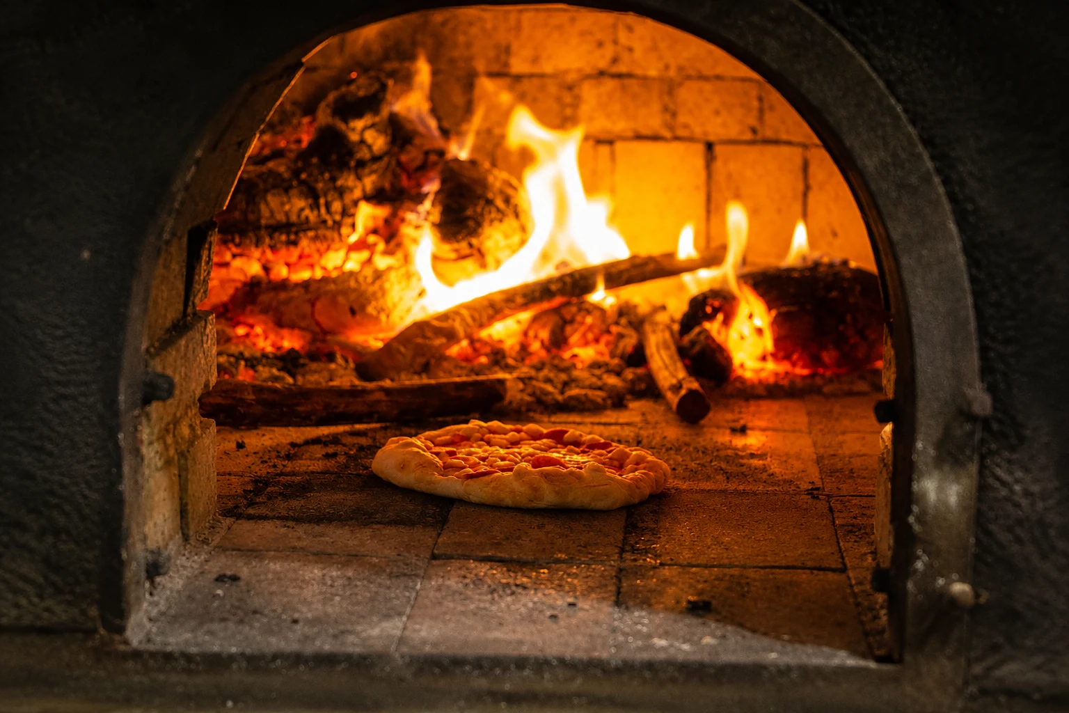 Pizza baking in the wood fired oven at the Pedro Barn Hotel pub